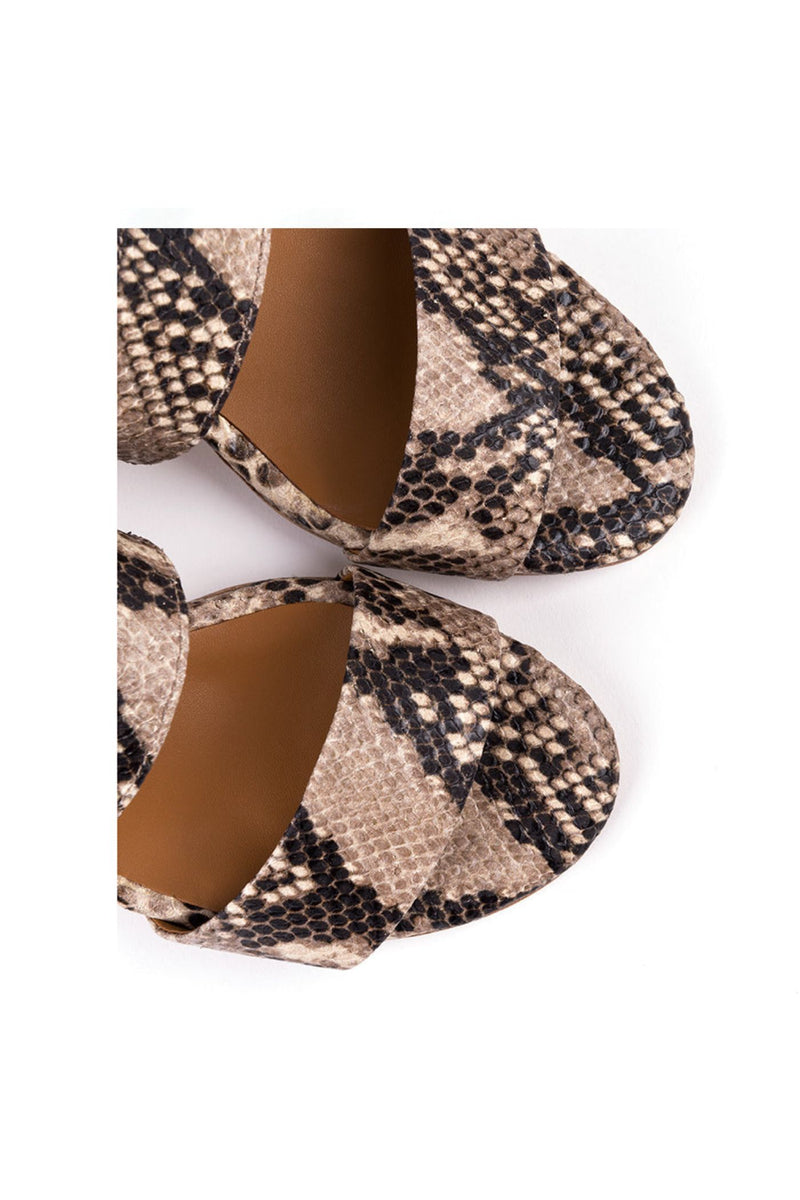 High-heeled sandals in natural patterned leather