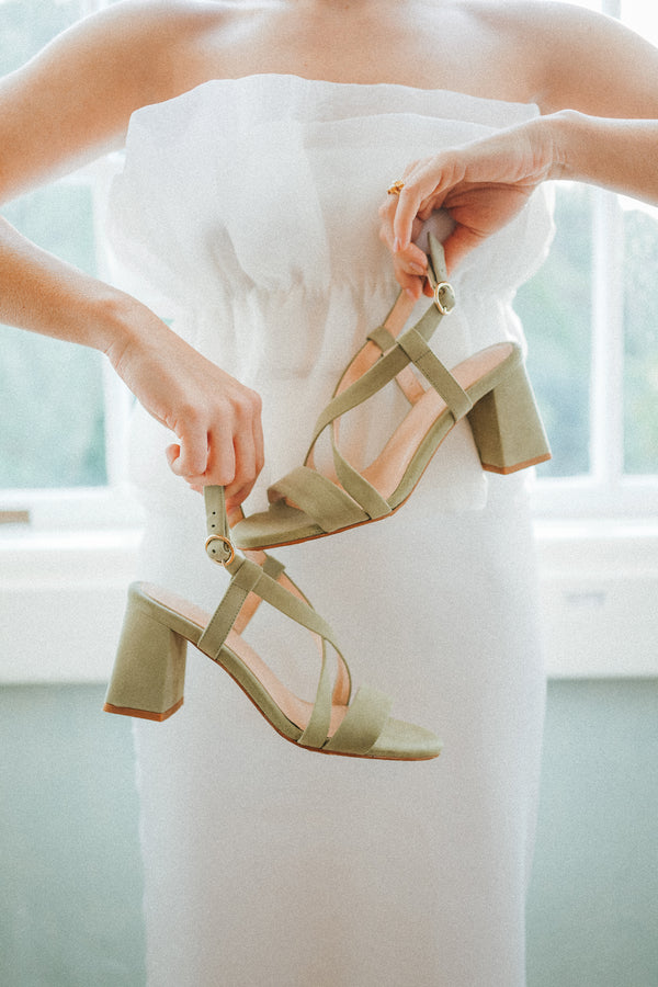 High heeled sandals with crossed straps in green suede