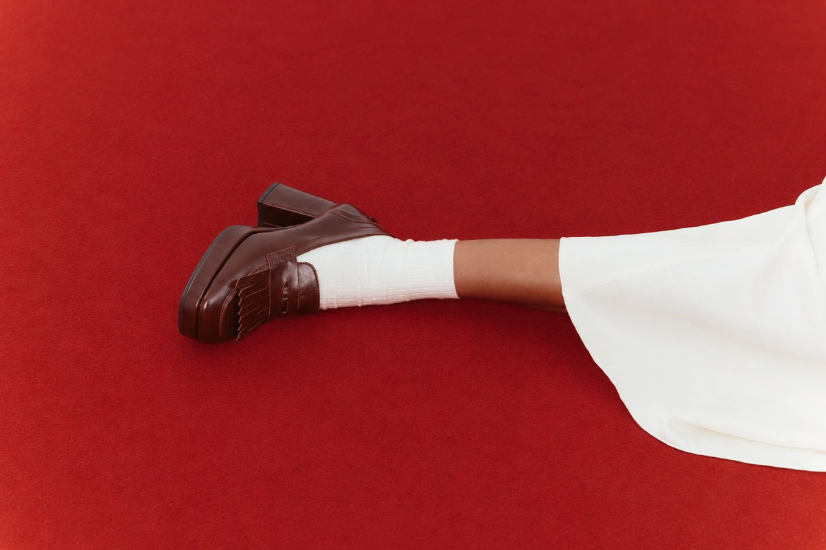Loafers com franjas e salto compensado em pele