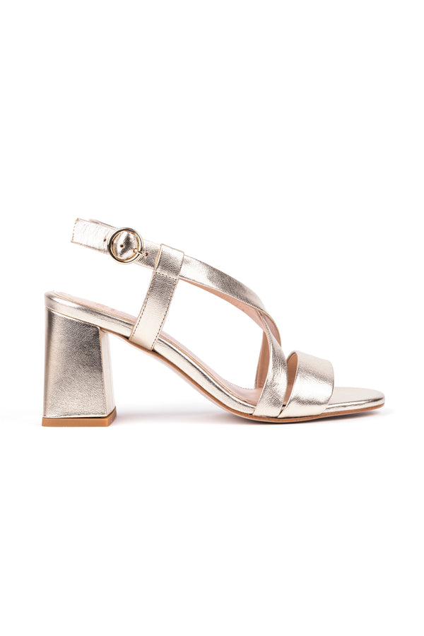 High heeled sandals with crossed straps in champagne metalic leather